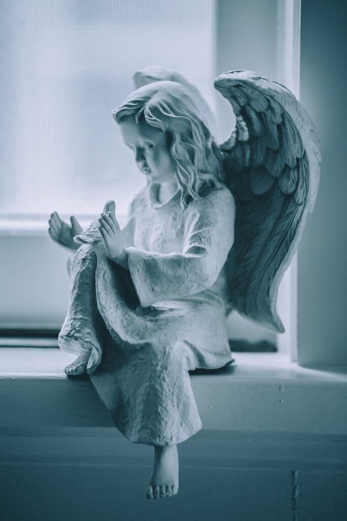 angel ceramic figurine on black table